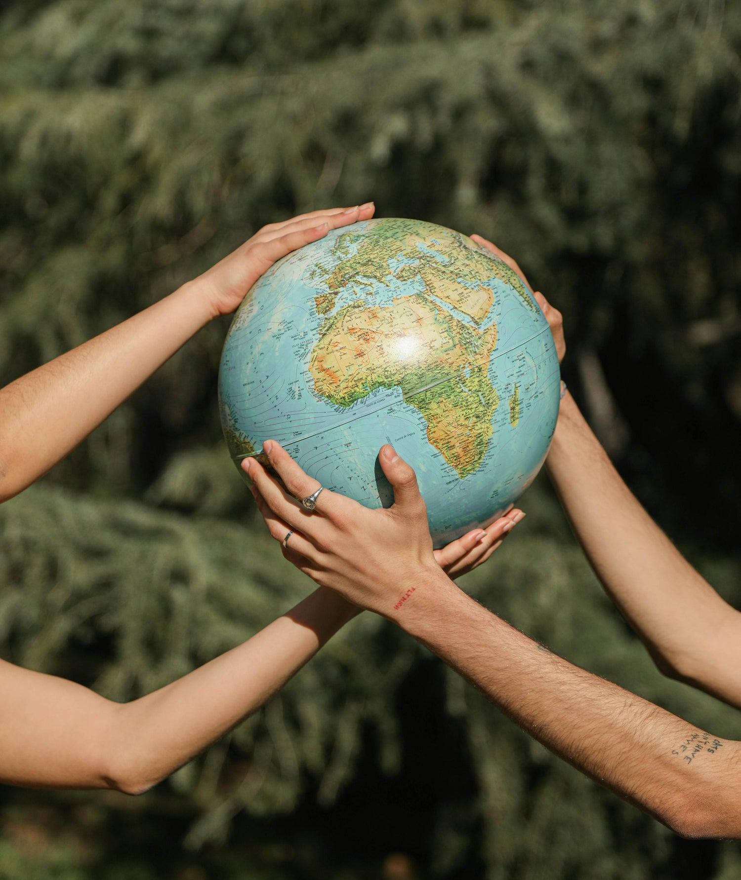 People holding the globe showing our responsibility towards earth and need to follow sustainable practices